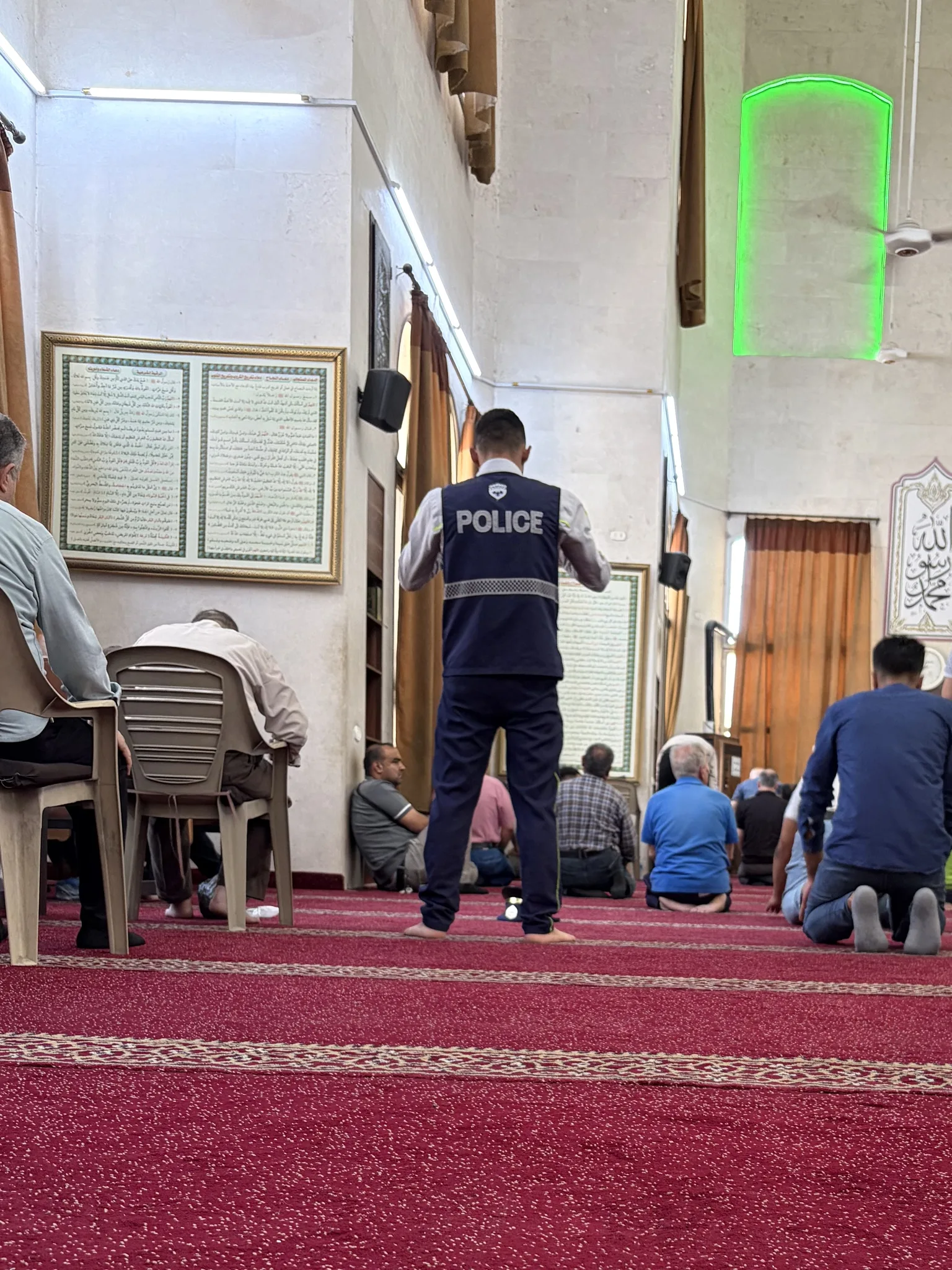 police officer praying in the mosque